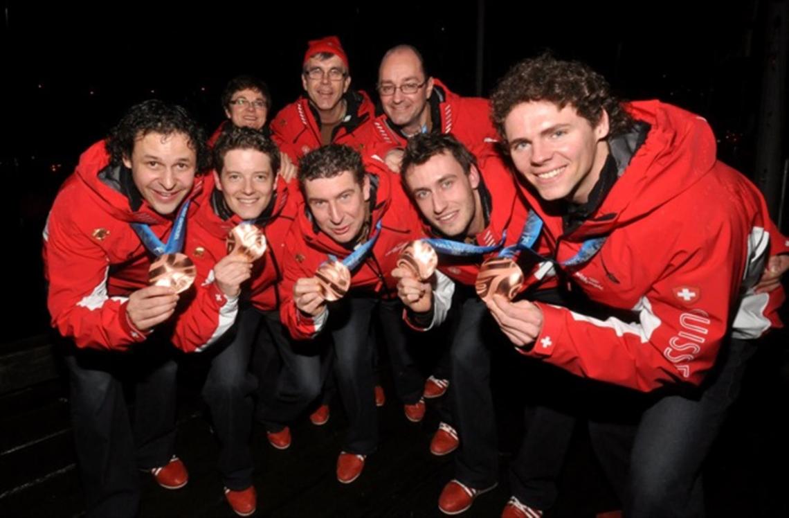 Swiss team wins bronze in men's curling in Vancouver.
