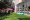 Space outside of the building with grass and people sitting and relaxing on the floor