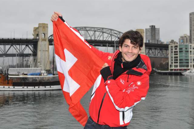 Swiss ice skater Stephane Lambiel proudly holding up the Swiss flag