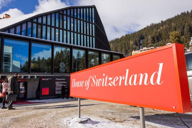 The House of Switzerland in Davos, with its prominent red signage welcoming guests to the venue.