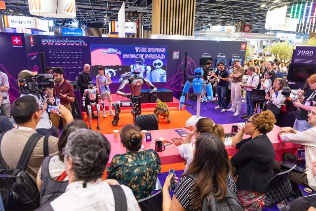 Visitors watching live robot demonstrations at the swisstech pavilion at VivaTech 2026 in Paris.